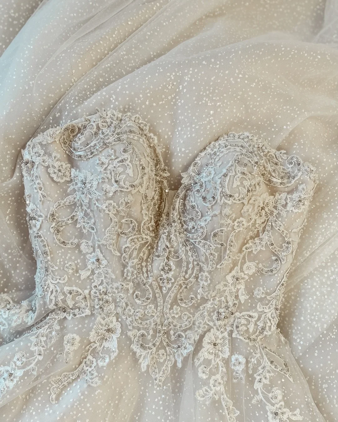 A Texture Tuesday fit for the Holidays! This week we are featuring Christina Wu&rsquo;s 15739! This classic A-line has a gorgeous heavily beaded cutout sweetheart bodice and dissolves into a magical sparkle dot tulle skirt. We only have one available