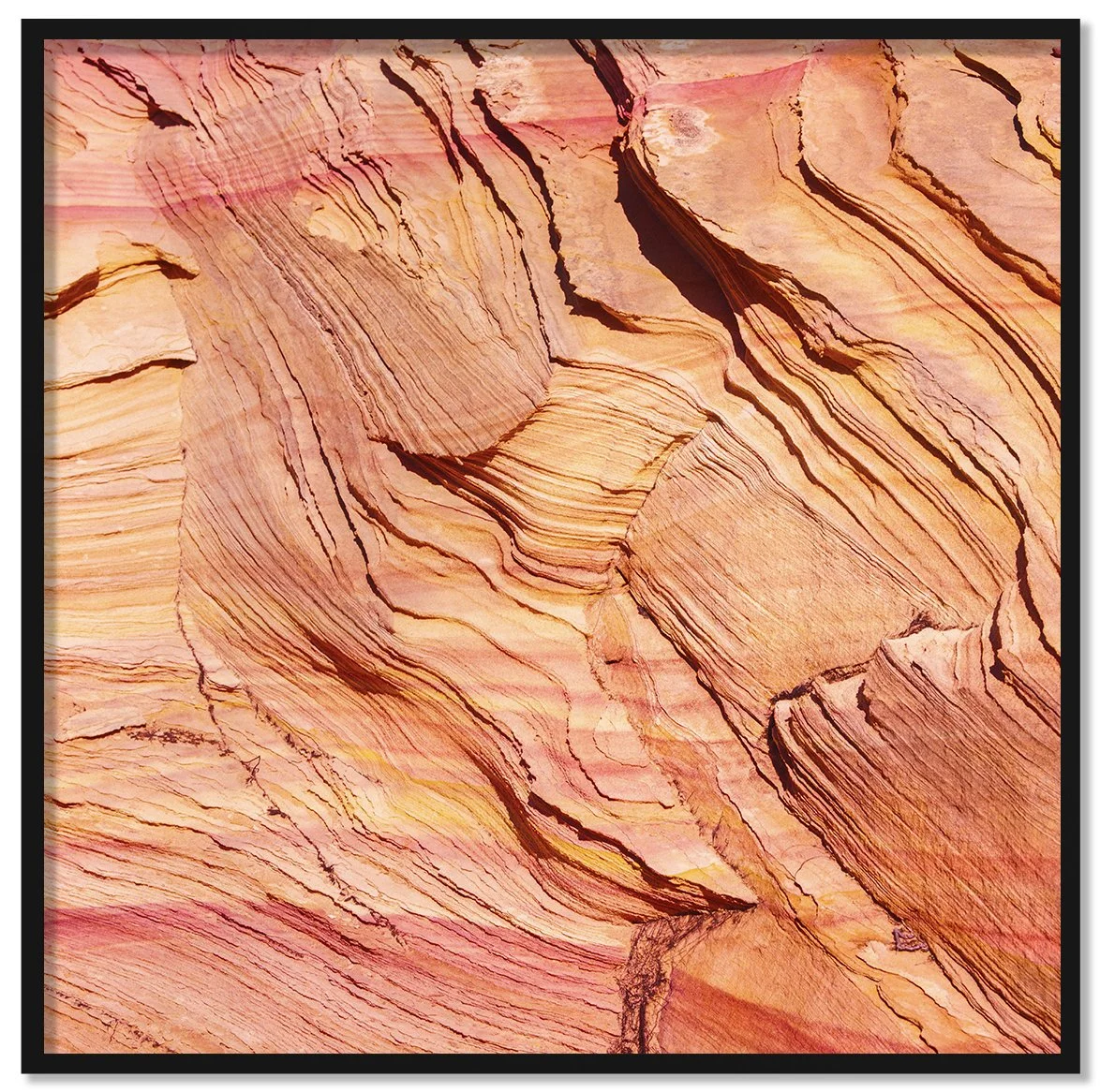 Waves framed fine art print by Luca Marziale, close view of orange and pink sandstone with fine wavy layers and sharp ridged edges, desert rock texture