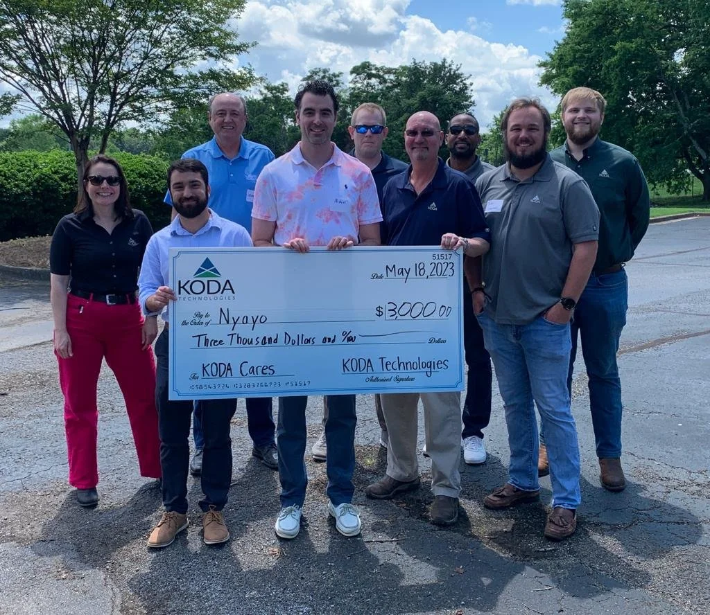 Michael and the KODA Technologies team posing with the donation