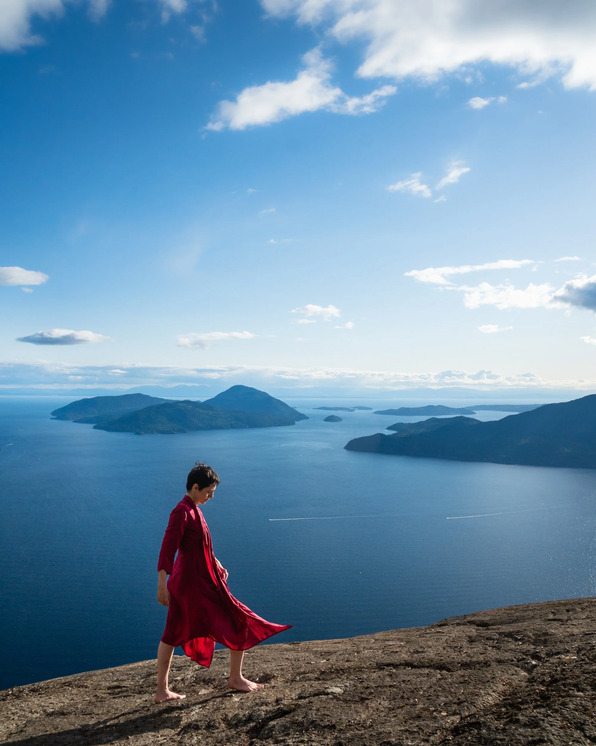 walking in red dress in front of Tunnel Bluff view