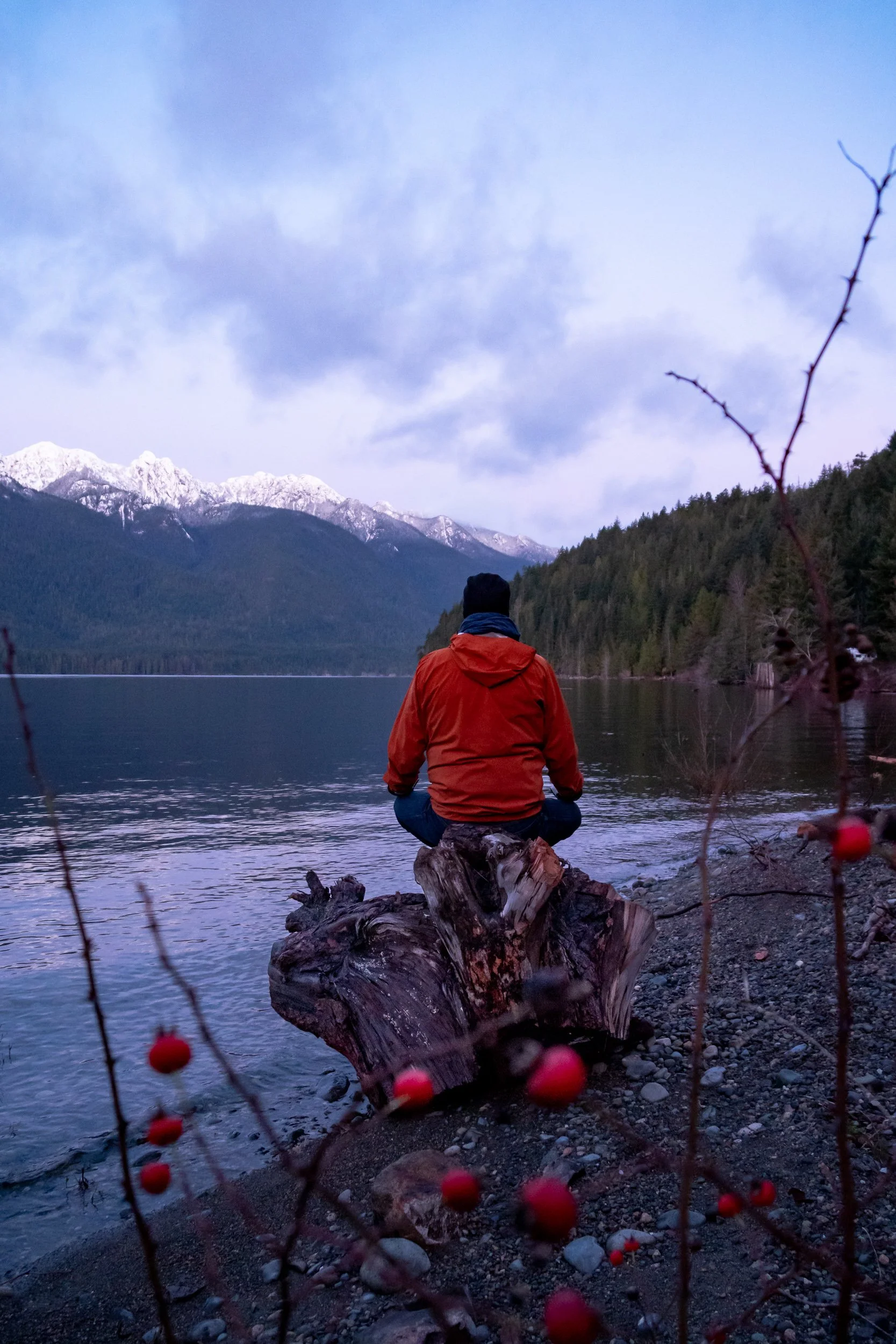 Meditating in front of a lake in winter