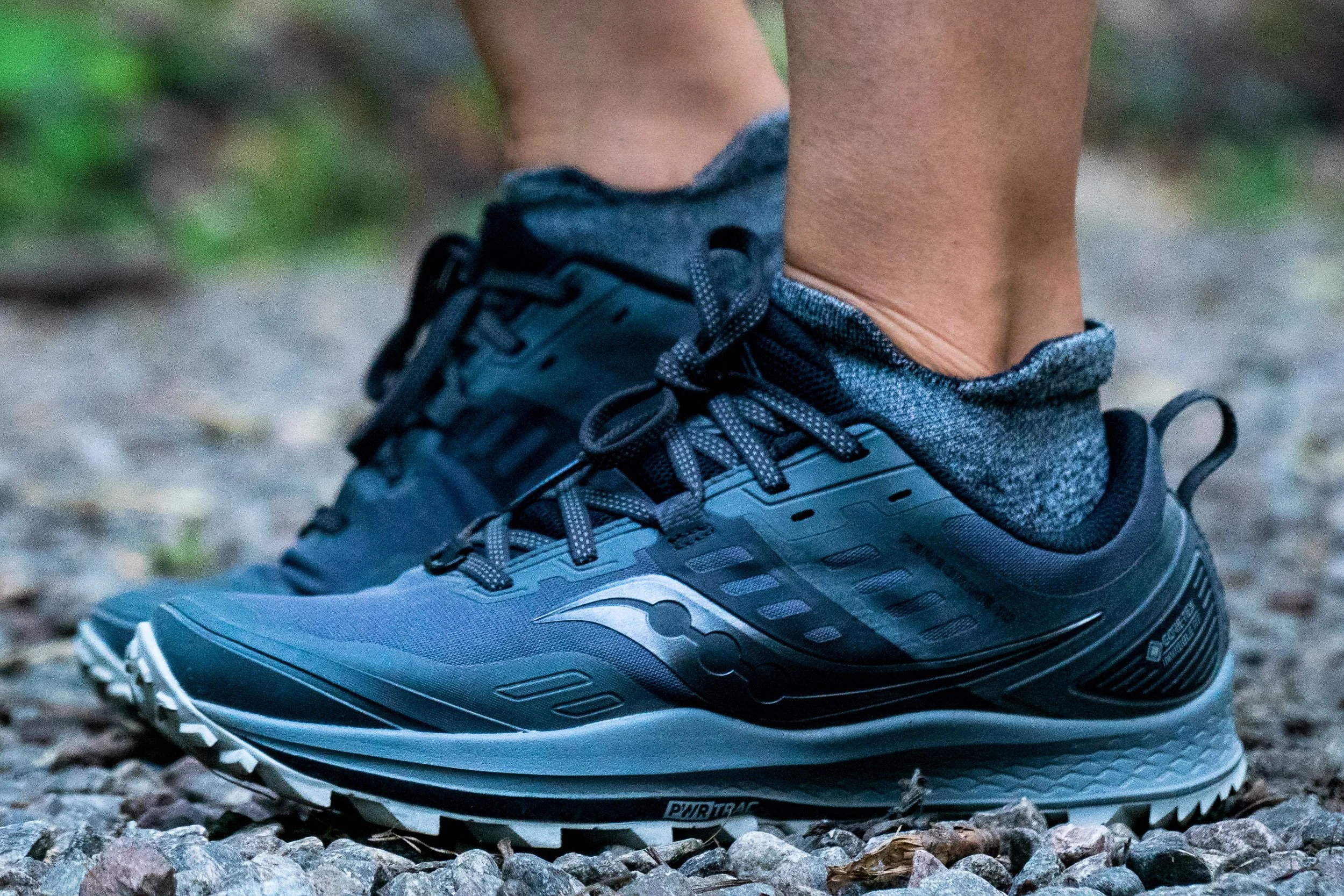 Saucony trail running shoes on foot