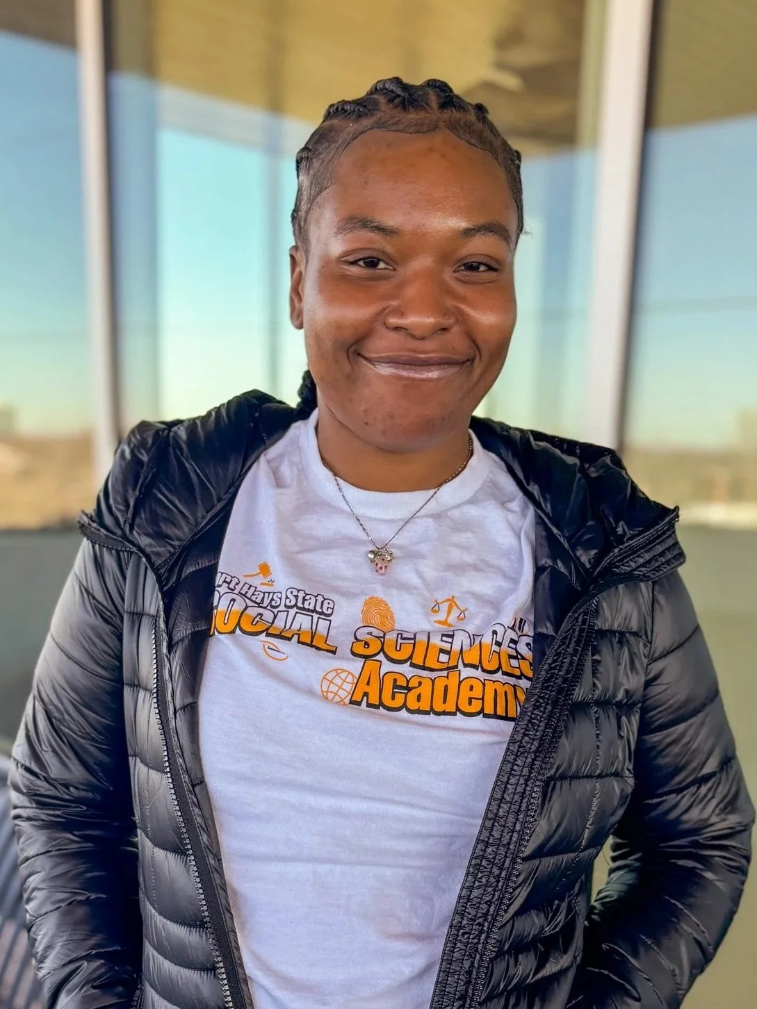 Headshot of woman in black coat smiling 