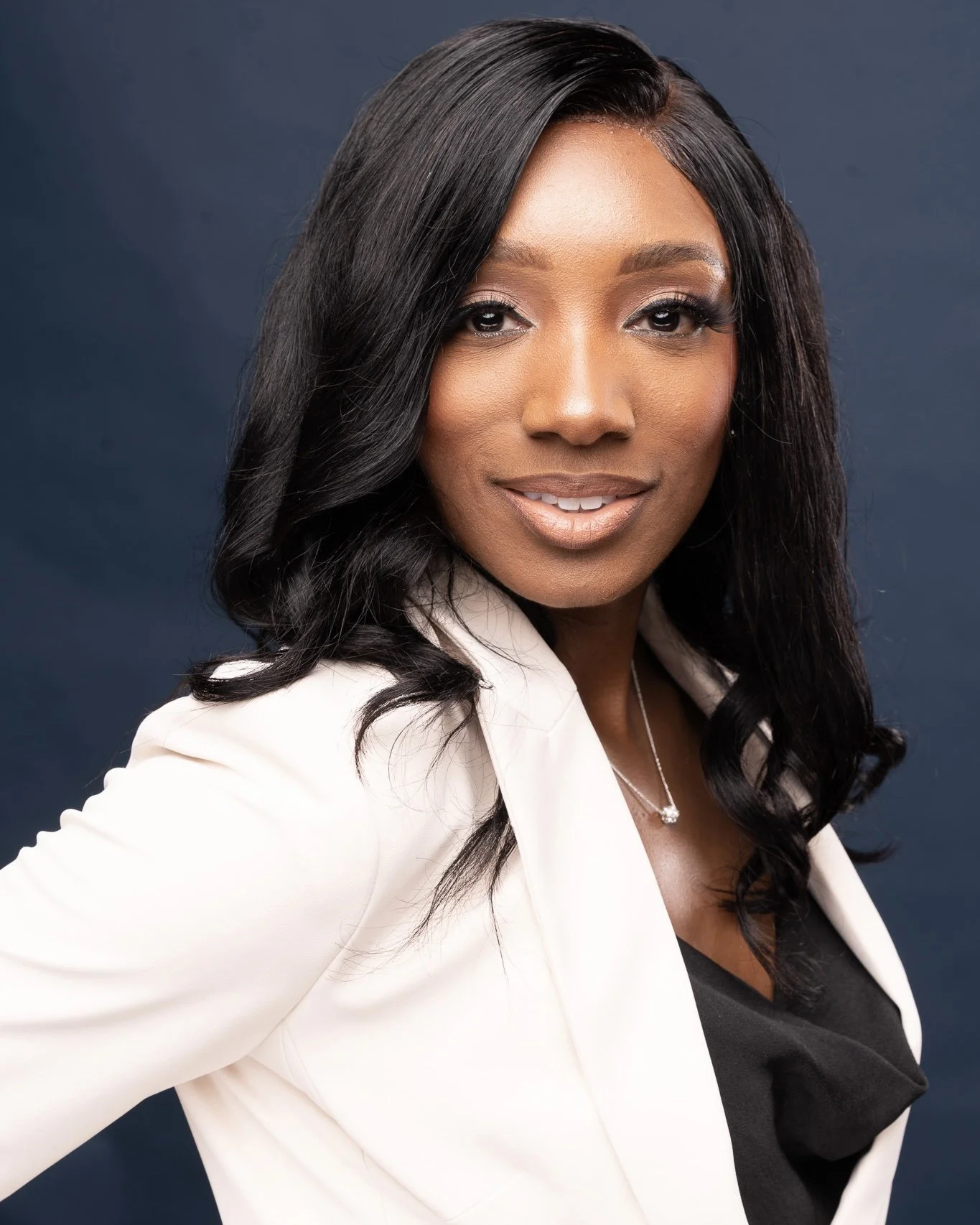 headshot photo of black woman in white blazer