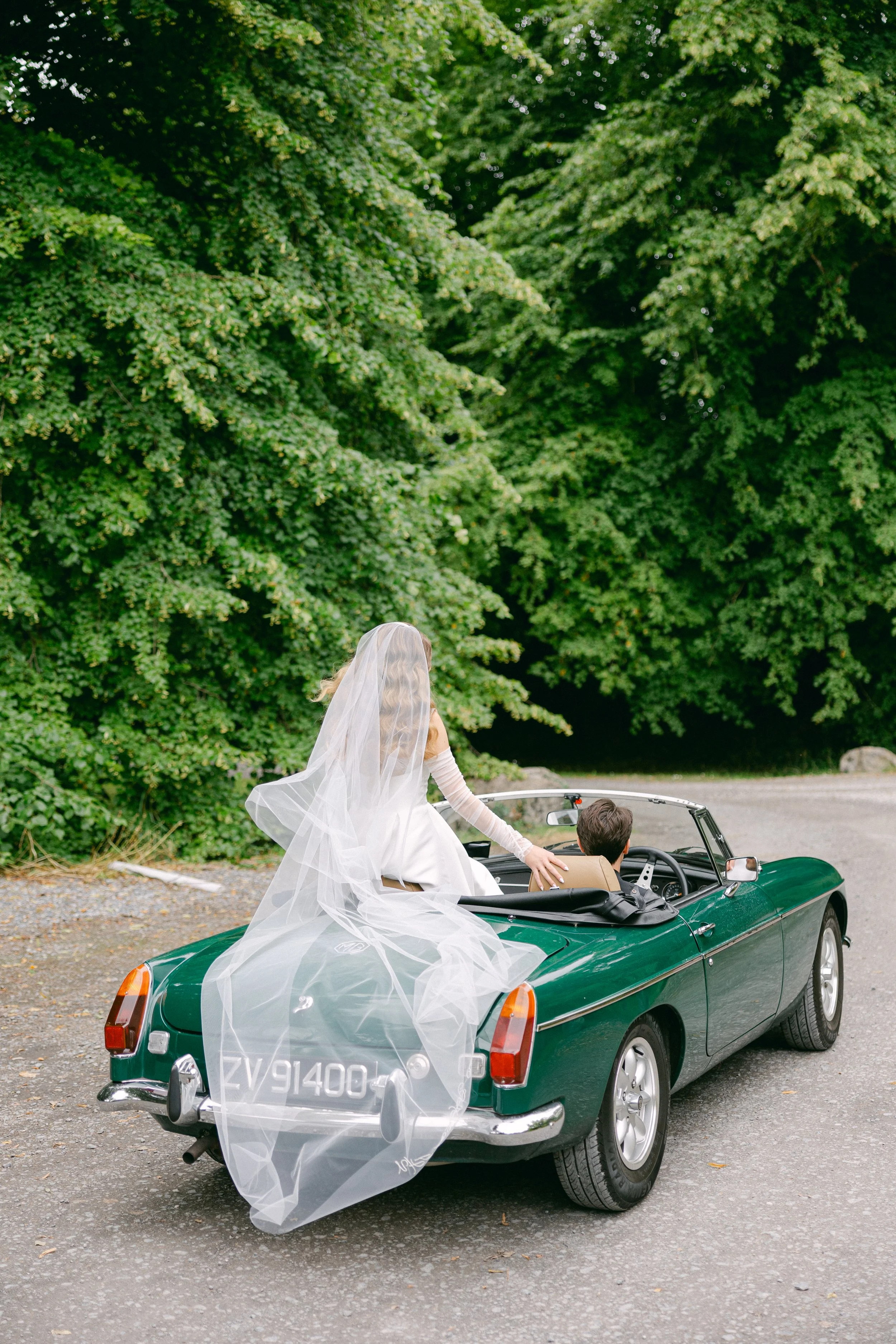 bride and groom in a vintage car gloster house wedding