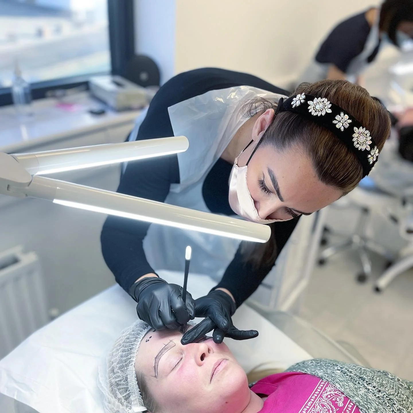 student doing microblading on live model on blades academy microblading course