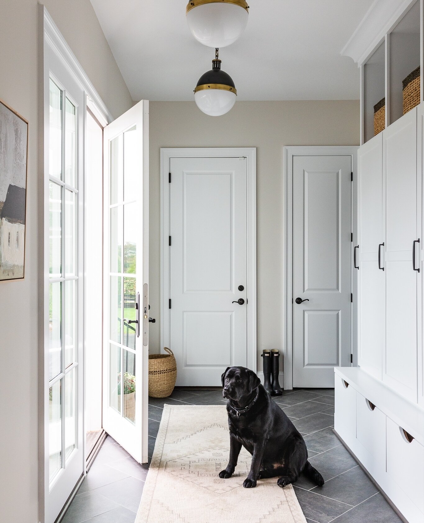 &quot;Great storage in this mudroom - love the tile floor set in a herringbone pattern!⁠&quot; said the super cute black lab.⁠
⁠
Photographer // christykosnic⁠photography⁠
Architect // @saraharmstrong_aia⁠
Build // @bowa_designbuild⁠
⁠
#custombuild #