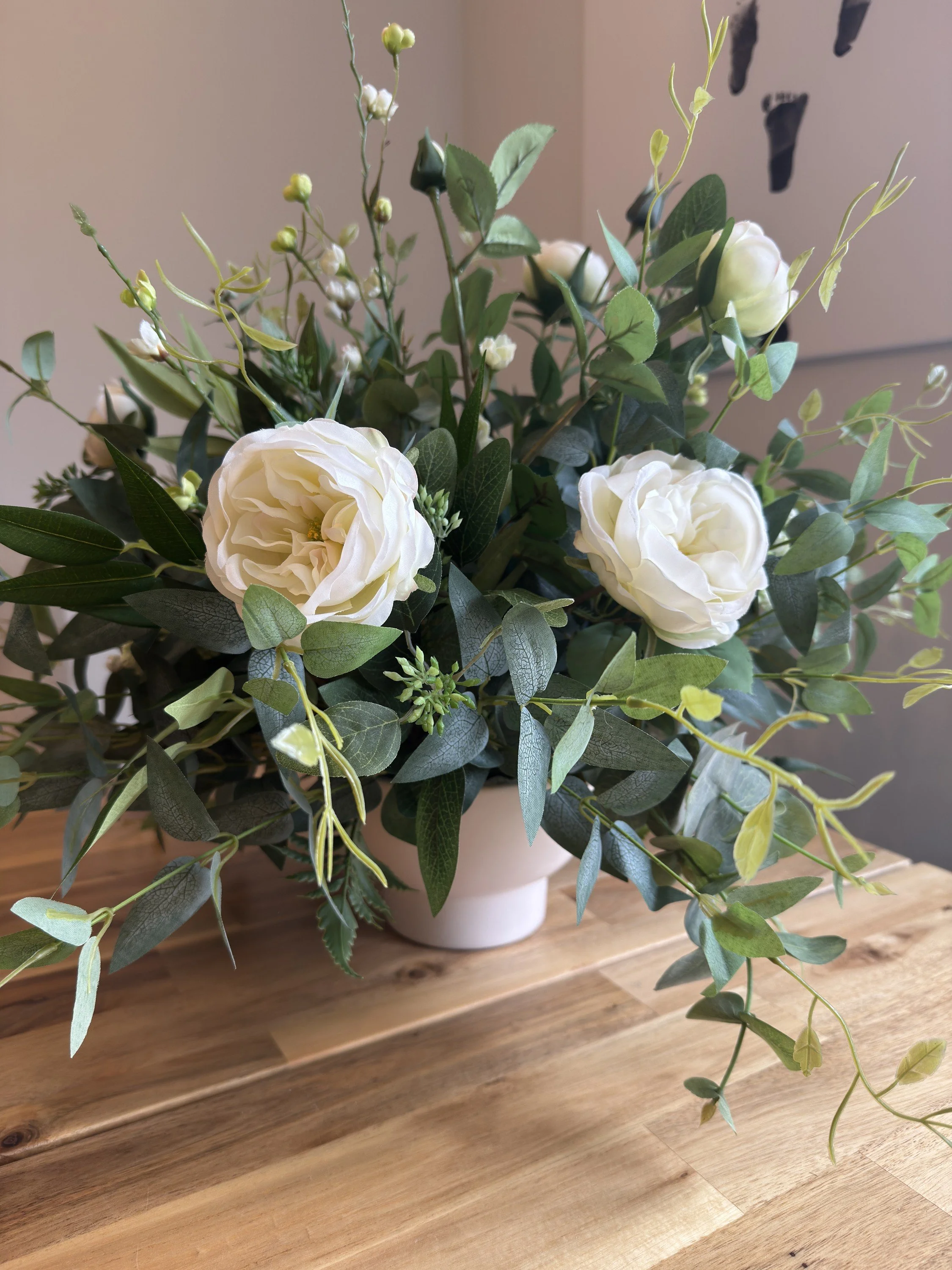 Timeless classic white and green artificial wedding flower bowl centrepiece featuring realistic roses, flowers and foliage, available to hire from Foliage & Faux for weddings across Derbyshire and the surrounding areas.