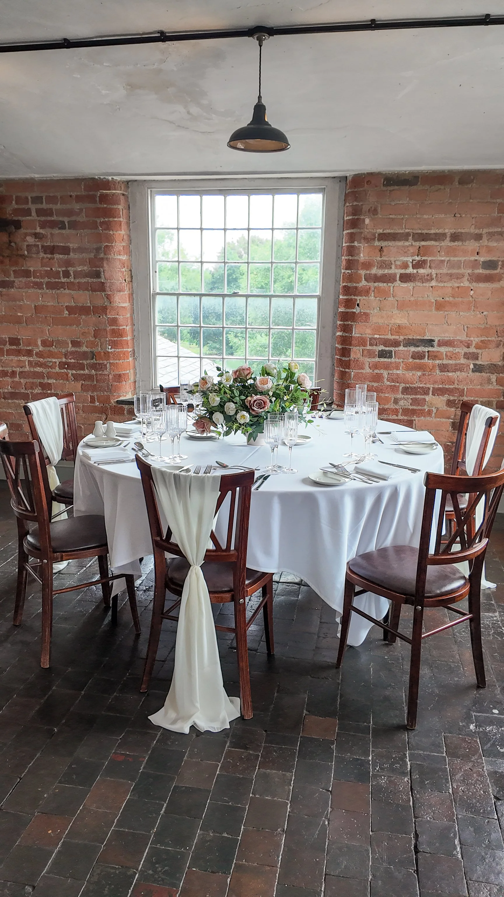 Blush pink artificial flower bowl centrepiece on a round wedding table