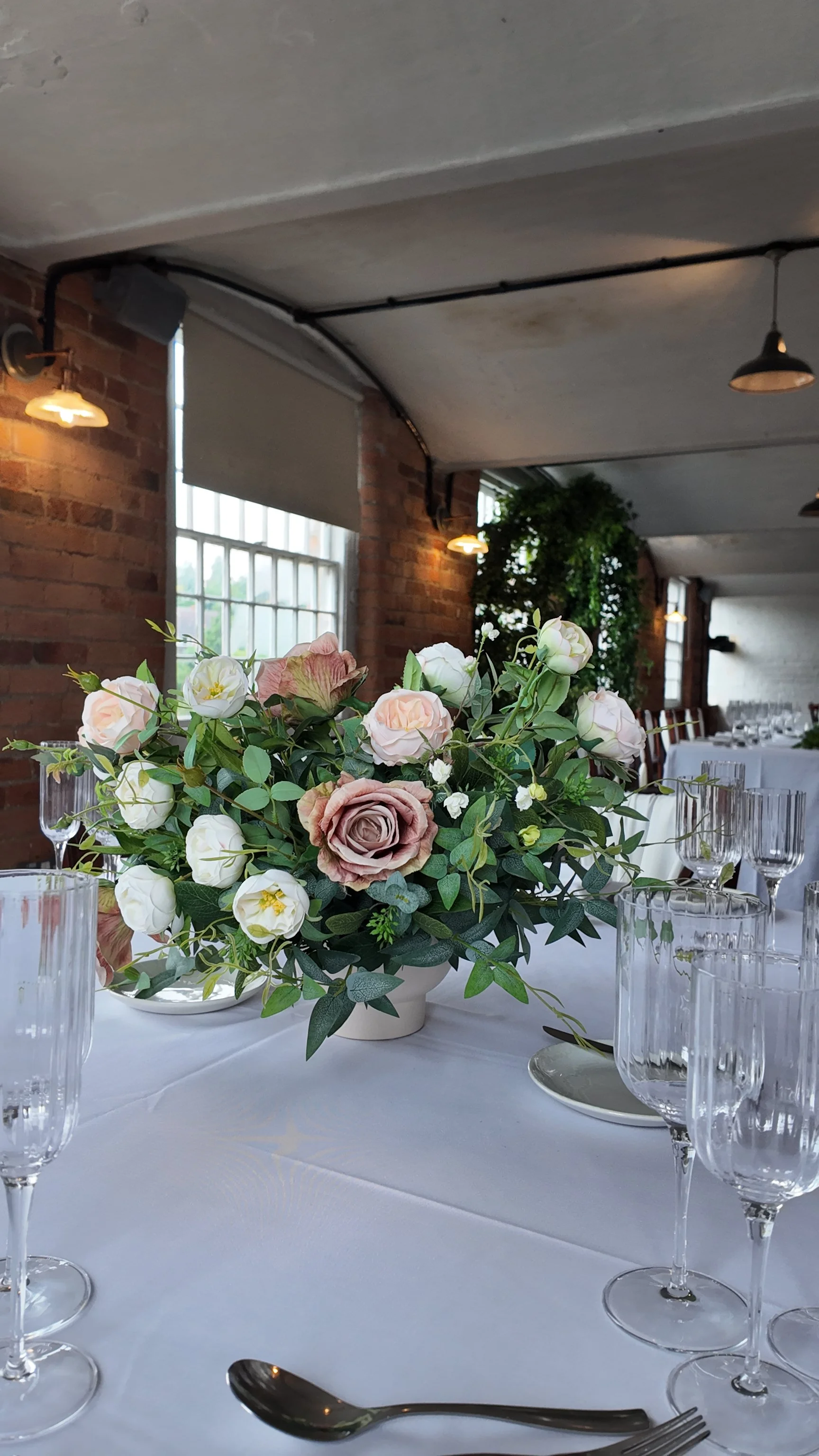 Realistic faux flower wedding centrepiece with blush roses and greenery