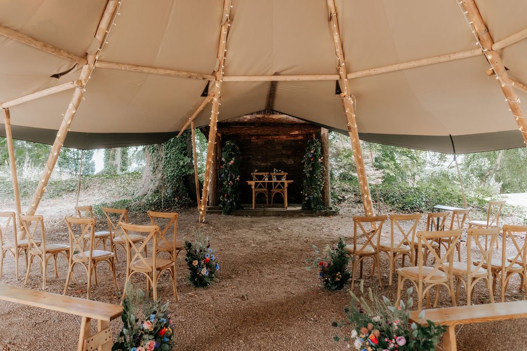 Discover artificial wedding flower hire for Tipis at Whatton House in Leicestershire. Explore our venue package, with ceremony flowers and table styling.