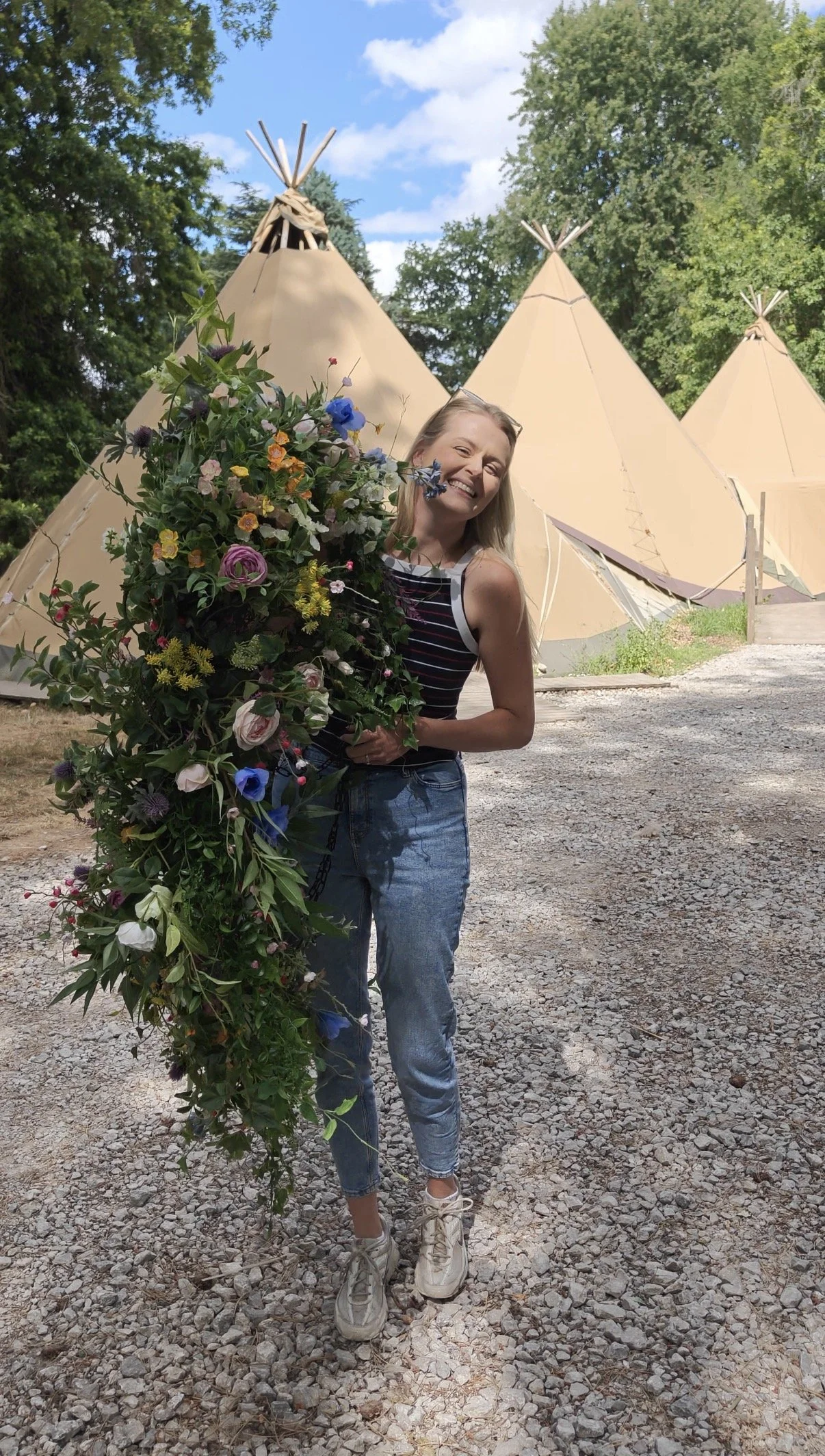 Setting up colourful artificial flower aisle arrangements for a wedding ceremony at Tipis at Whatton House