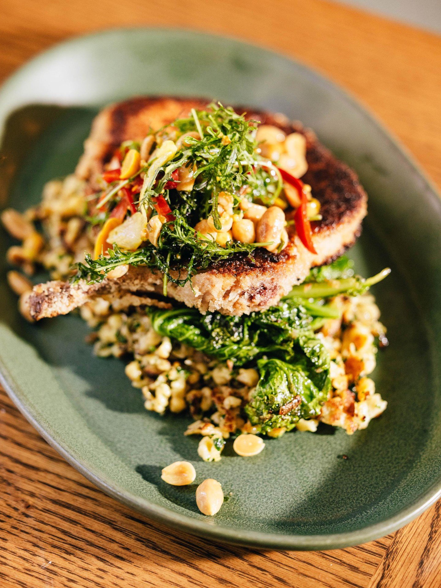 Our @PeculiarPigFarm pork chop schnitzel is crisp and golden, with roasted onion spaetzle, mustard greens, and pickled peanut salad. A dish that bridges Southern flavors and European comfort, crafted for those evenings when you want something hearty,