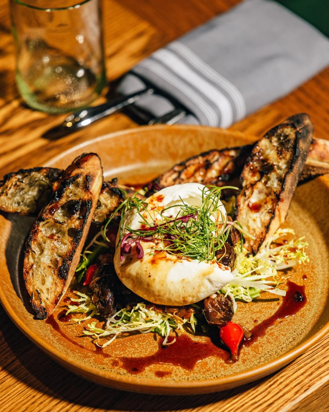 Creamy burrata meets salty country ham, sweet caramelized onions, and balsamic figs. All served with grilled country bread that&rsquo;s made for sharing &mdash; or not. You know how we roll.