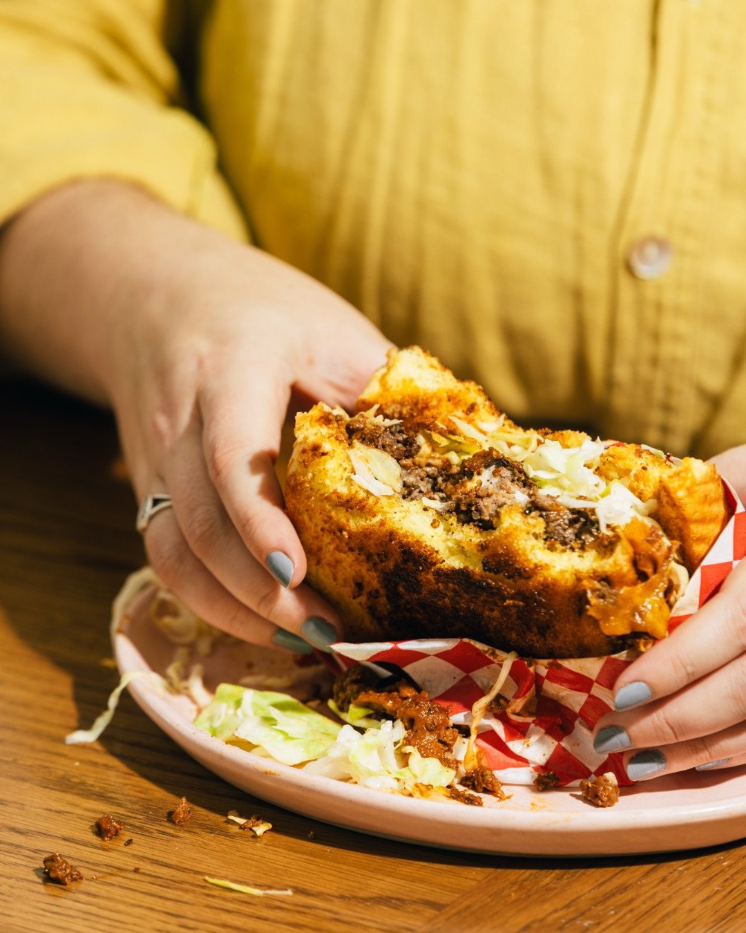 The K-Town. A perfect smash burger with house chili, slaw, sharp cheddar, kitchen sink mayo, on a challah bun.