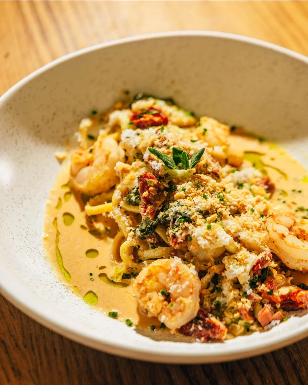 Bucatini with shrimp, soppressata, wilted greens, and cherry tomato. A little brightness from a dash of limoncello, a little heat from Calabrian chili, finished with lots of pecorino.