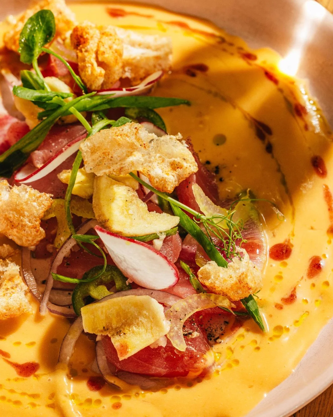 The latest iteration of our tuna crudo is dressed up with jipijapa sauce, a traditional preparation from Ecuador's Manab&iacute; coast, made by blending roasted peanuts, fish broth, lime, and spices into a creamy, savory emulsion that balances richne