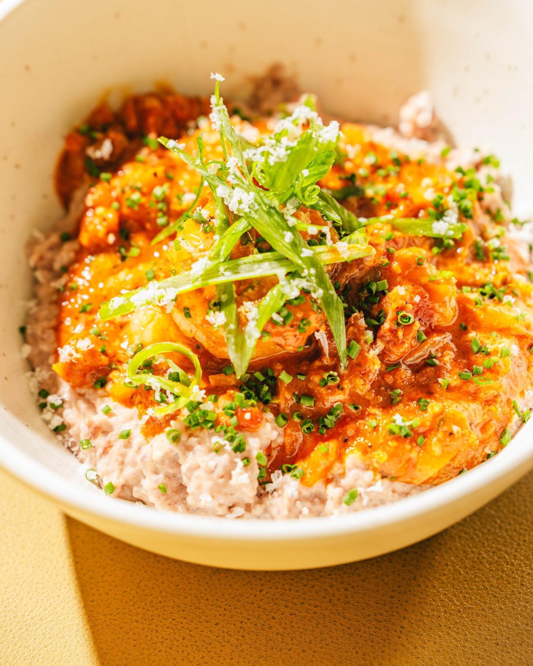 We pride ourselves in raising the bar in city known for it' Shrimps &amp; Grits. Tasso ham, creamy tomato fondue, fried pimiento cheese grits. It's no average Shrimp and Grits and we know you'll agree.