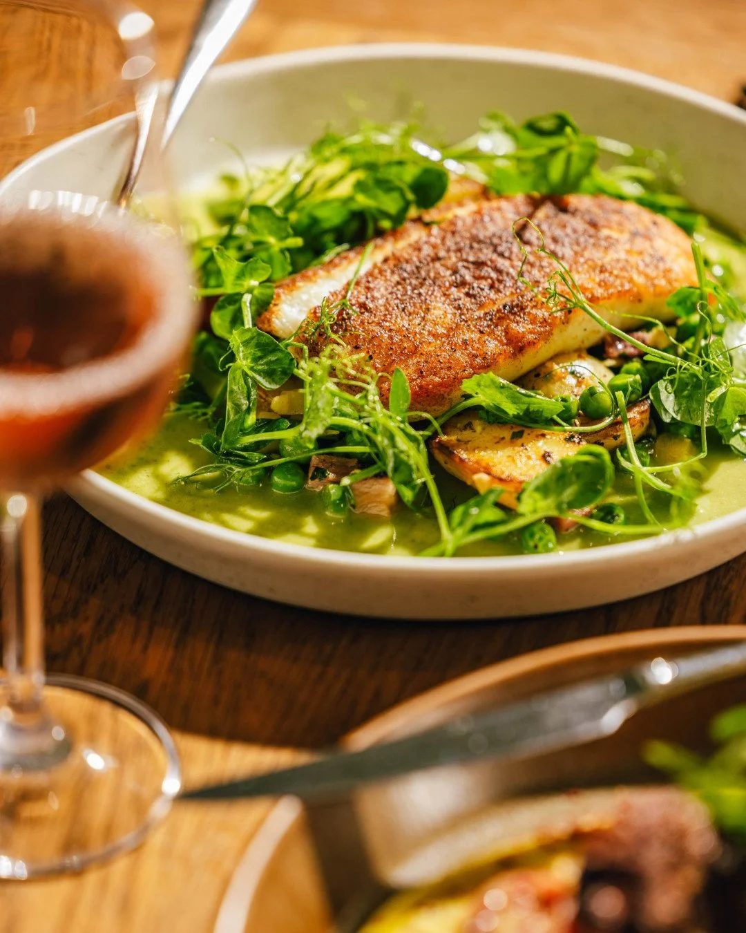 It changes with the tide, but today's Daily Coastal Catch is this: fresh fish with smoky tasso ham, sweet peas, bell pepper, butter ball potatoes, and herbaceous butter.
