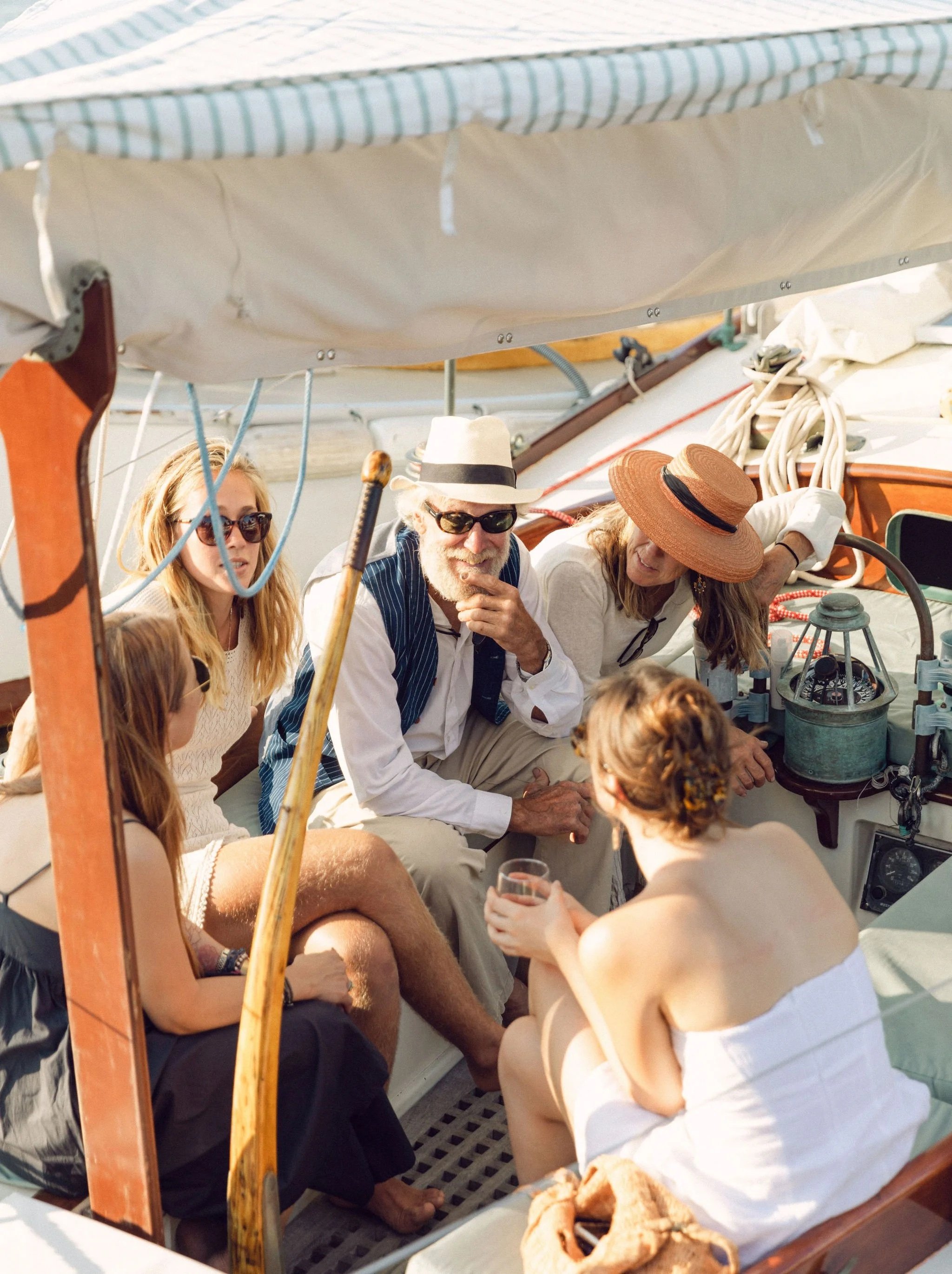 Waterfront royalty, the Gannon's of Gannon and Benjamin Marine Railway enjoy a chat on board their custom designed and built wooden yacht. One of many authentically Martha's Vineyard moments captured at the Sail MV Seafood Buffet and Auction, an annu