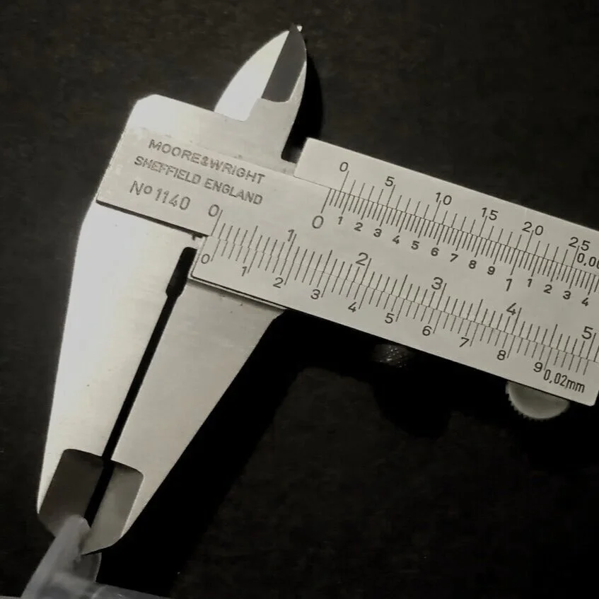 A photograph of a pair of callipers measuring a product. Phoenix Consultants.