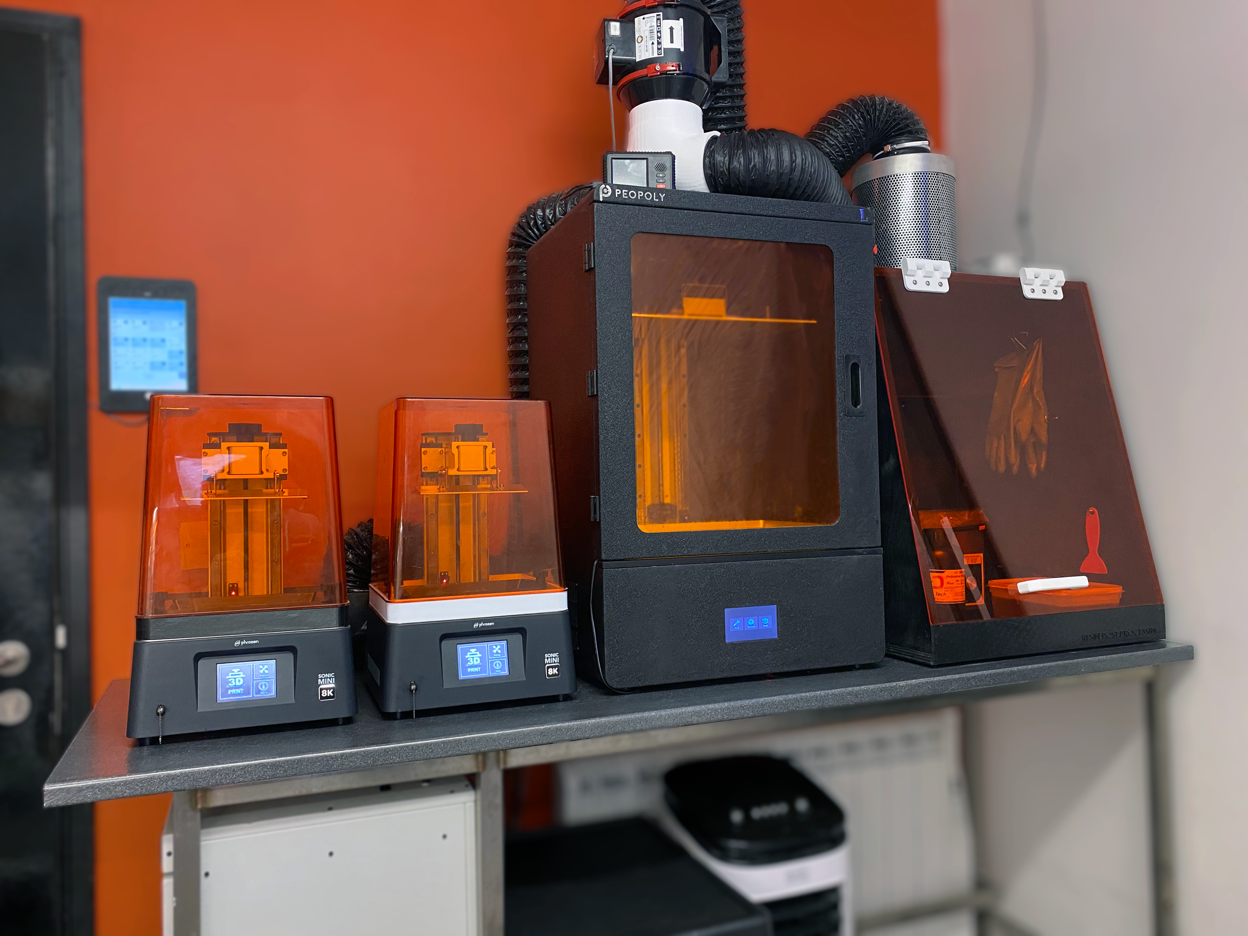 A photograph of two small and one large format resin 3d printers in Phoenix Consultants' resin 3d printer lab.
