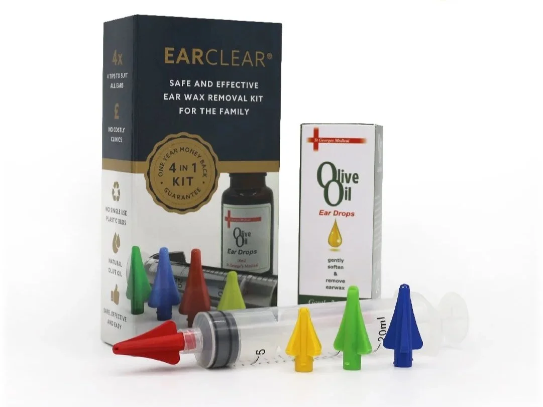 Earwax removal kit with colorful earwax removal tips, syringe, and boxes of olive oil ear drops and earwax removal solution.