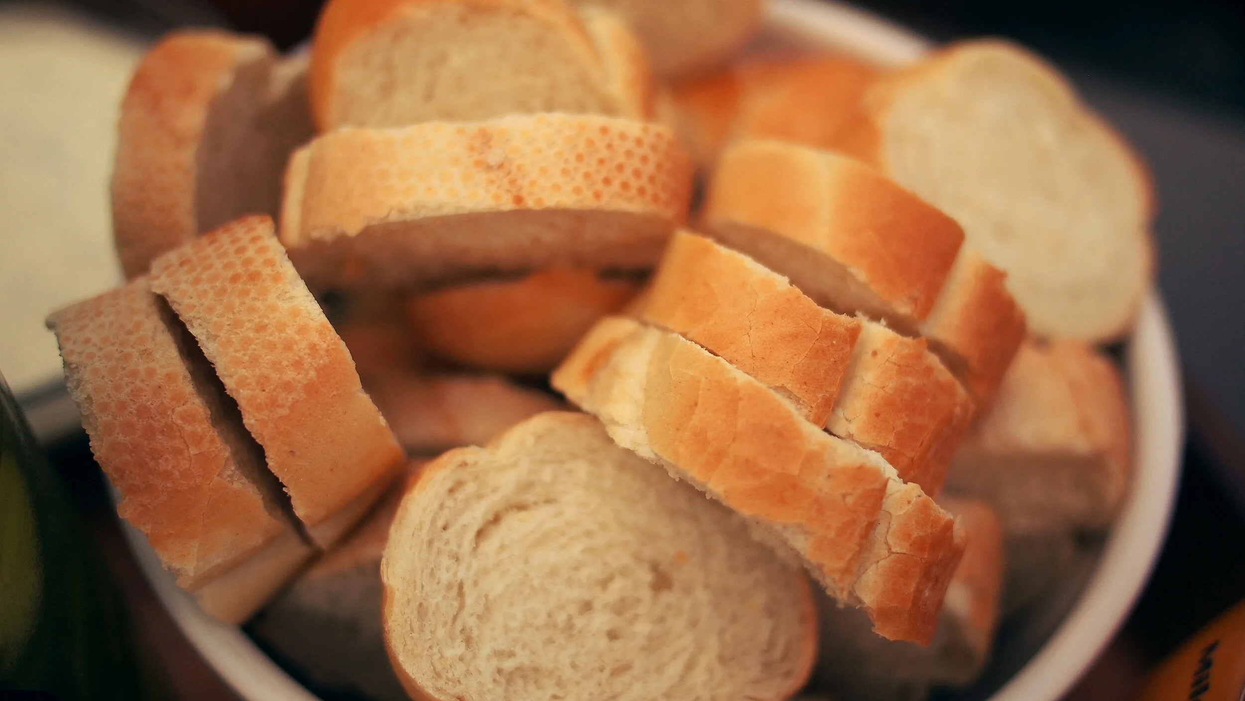 Close-up of sliced baguette bread in a bowl.