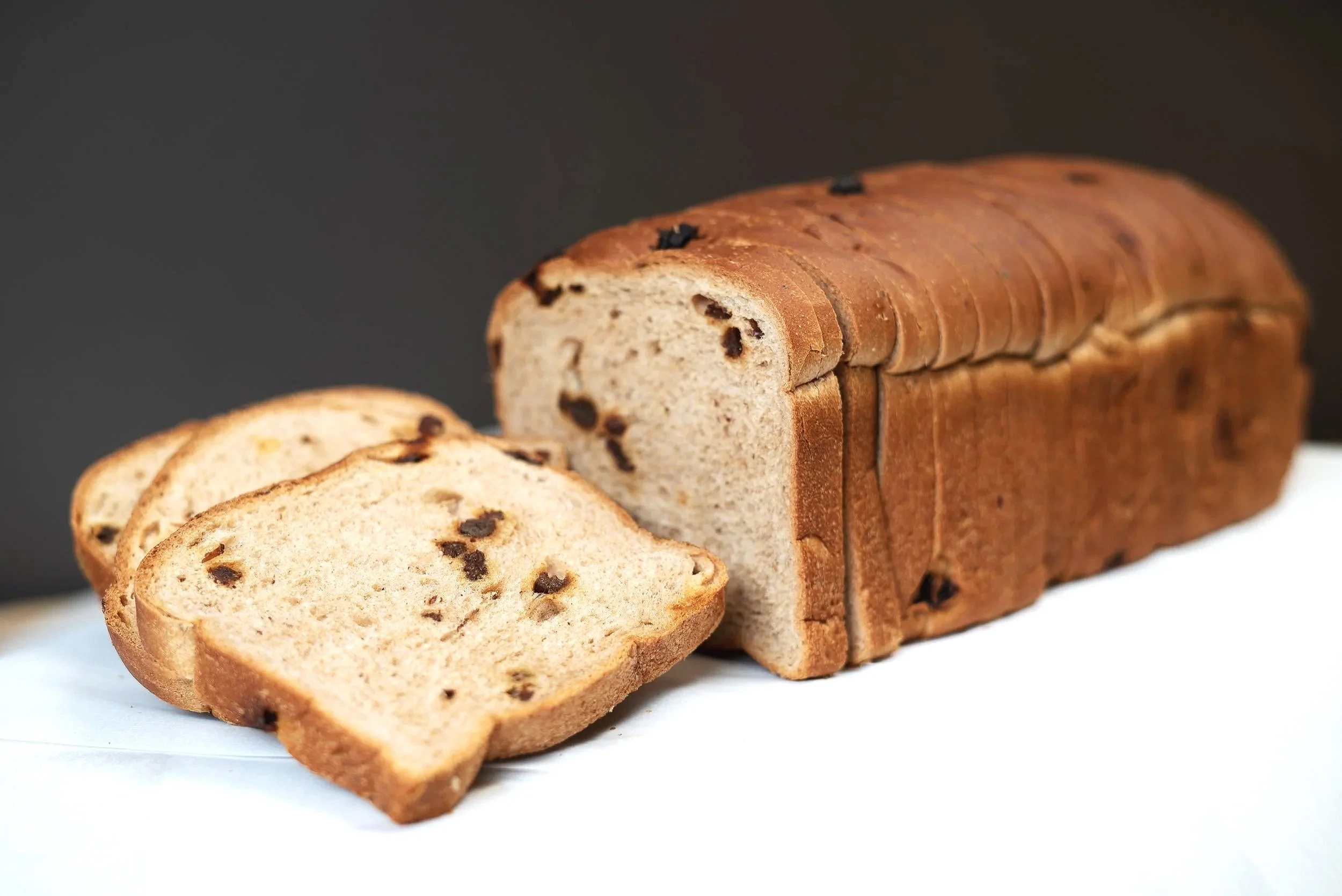 Our Cinnamon Raisin Bread is a soft, fragrant loaf swirled with warm cinnamon and filled with sweet, juicy raisins, creating a comforting balance of gentle sweetness and aromatic spice—delicious for breakfast, toasted with butter, or enjoyed anytime 