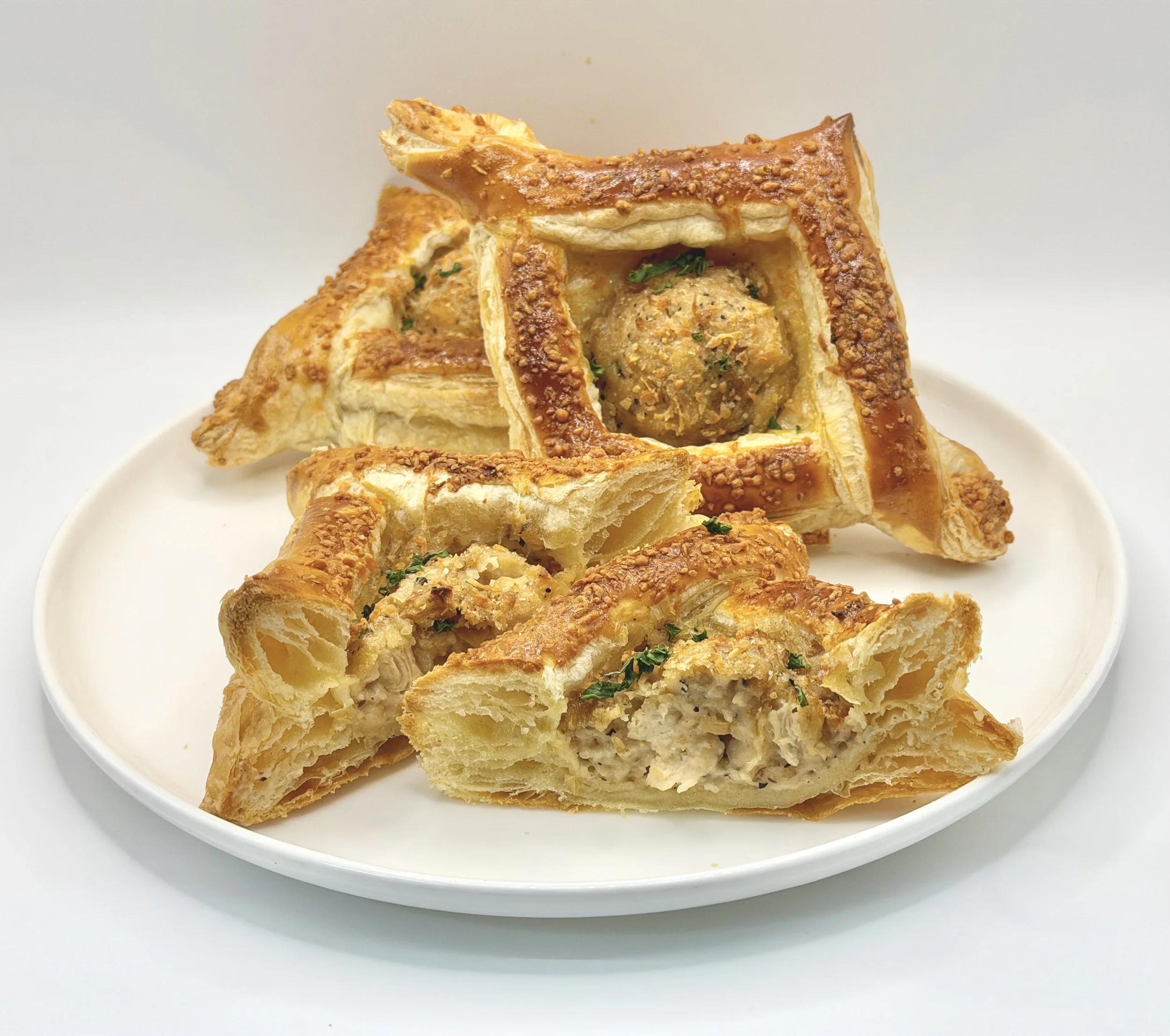 Our Chicken Alfredo Puff Pastry features tender seasoned chicken in a rich, creamy Alfredo sauce, wrapped in golden, flaky puff pastry and sprinkled with Parmesan cheese before baking for a deliciously savory, buttery finish.