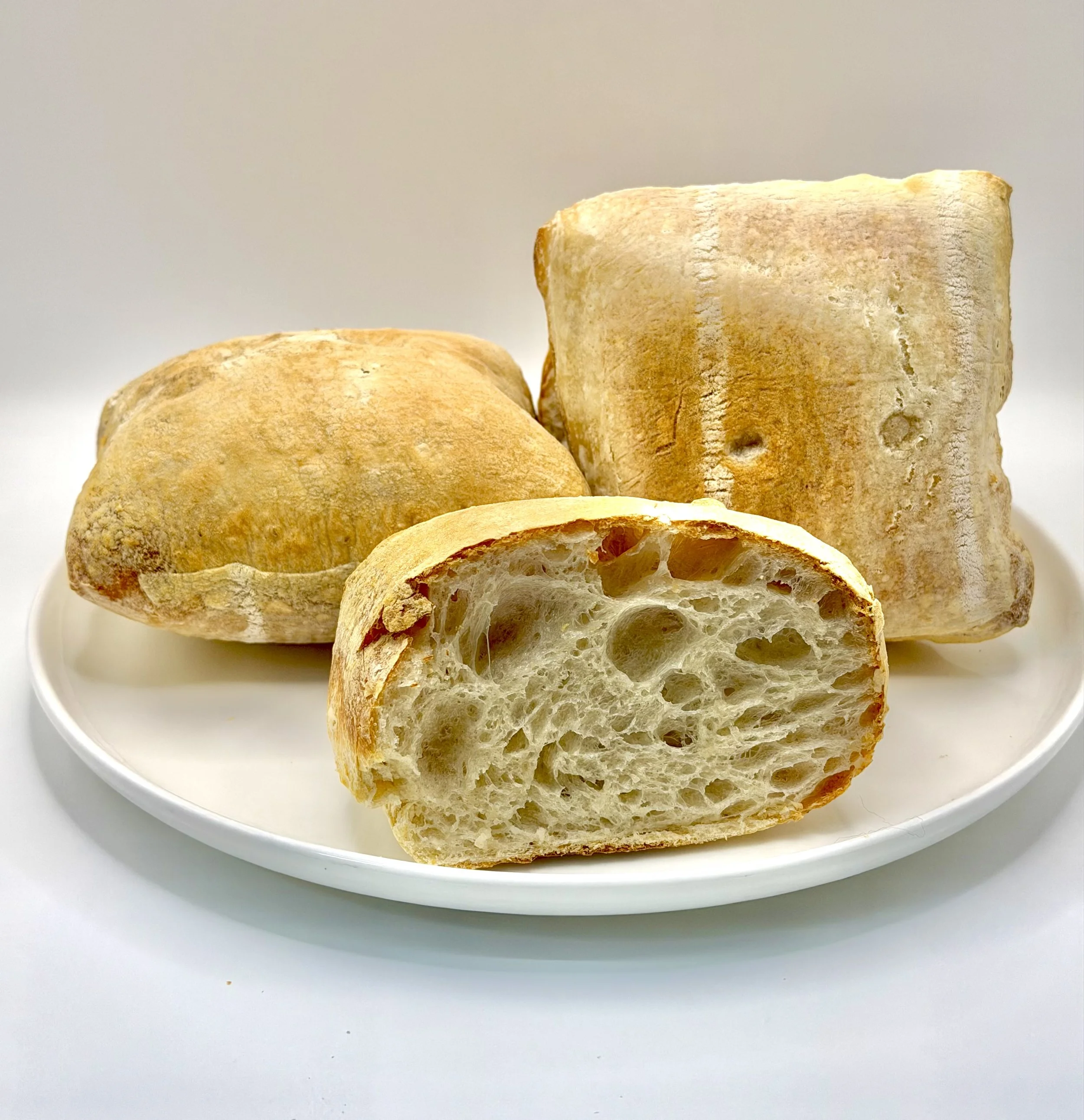 Our Artisan Ciabatta Bread is baked with a crisp, golden crust and a light, airy interior with signature open holes, offering a rustic flavor and satisfying texture that makes it perfect for sandwiches, paninis, dipping, or simply enjoying fresh with