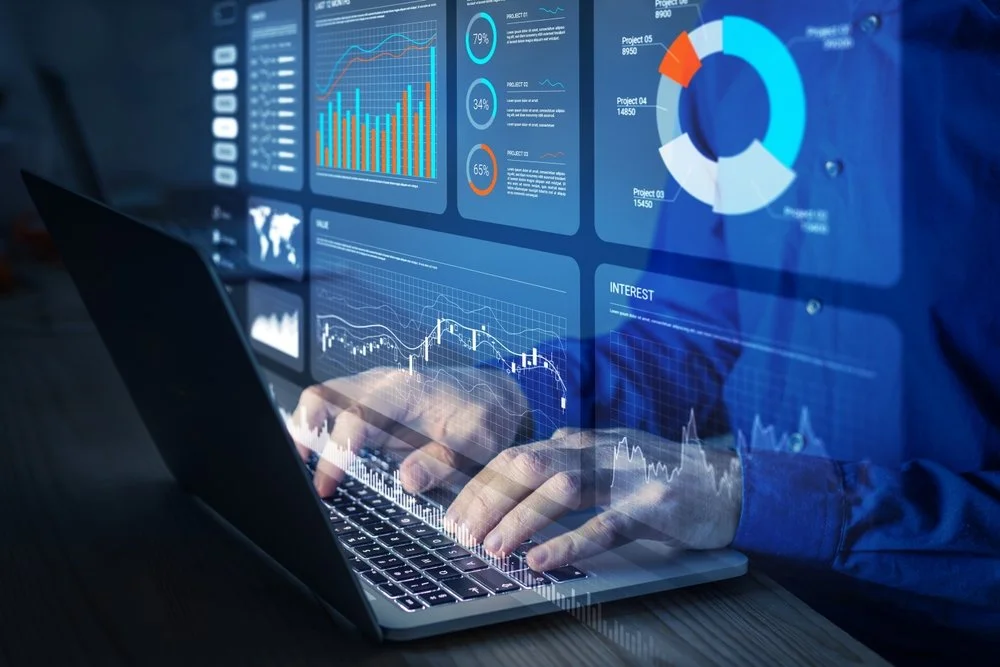hands on a computer working with financial charts