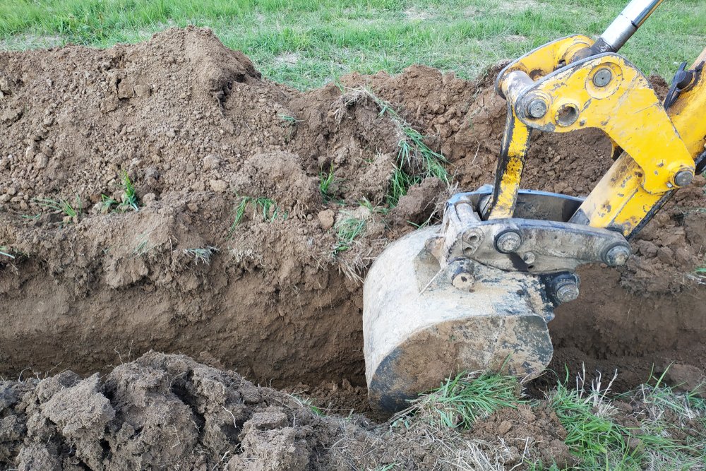 back hoe digging trench