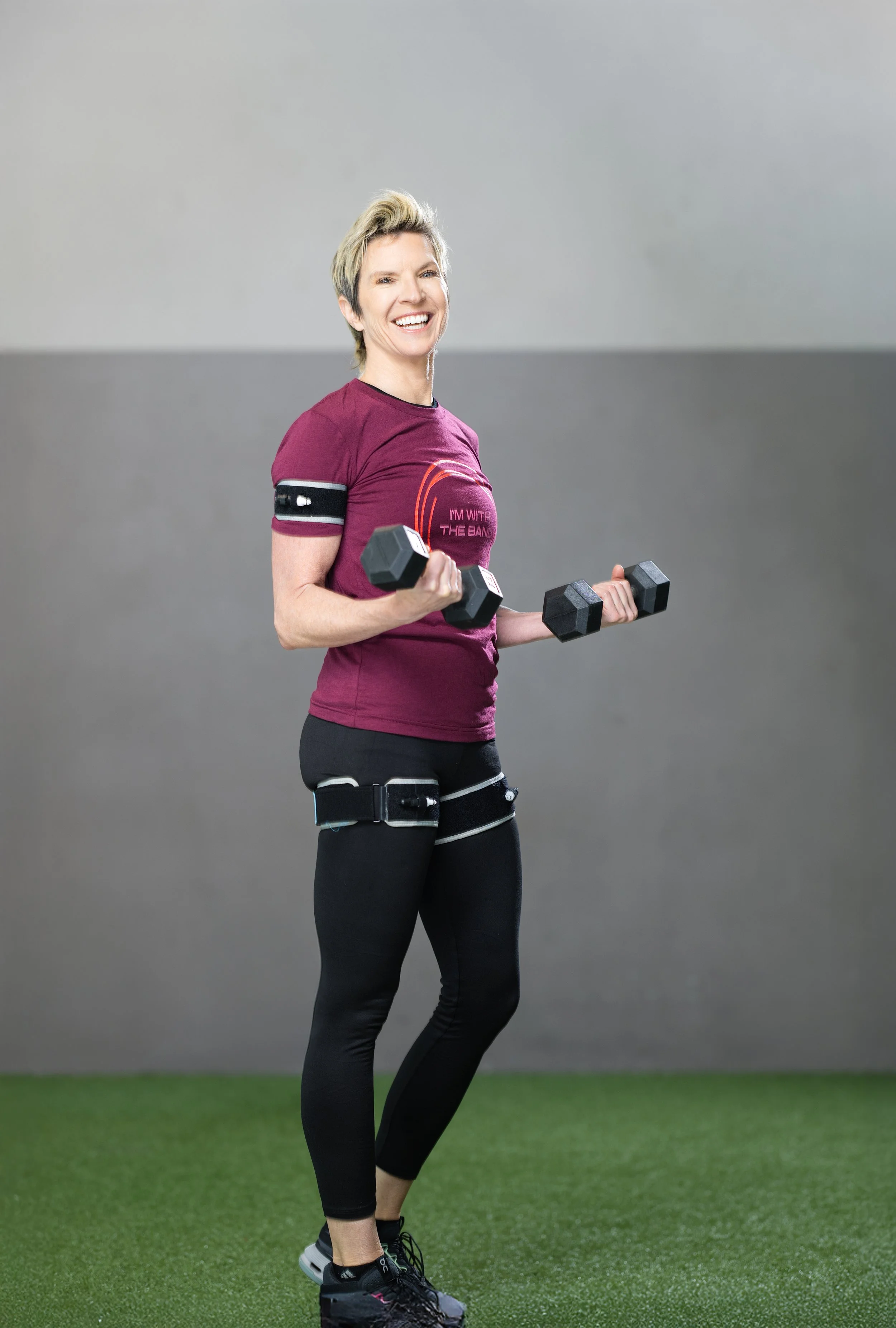 Ashley Selman wearing BFR bands doing a biceps curl