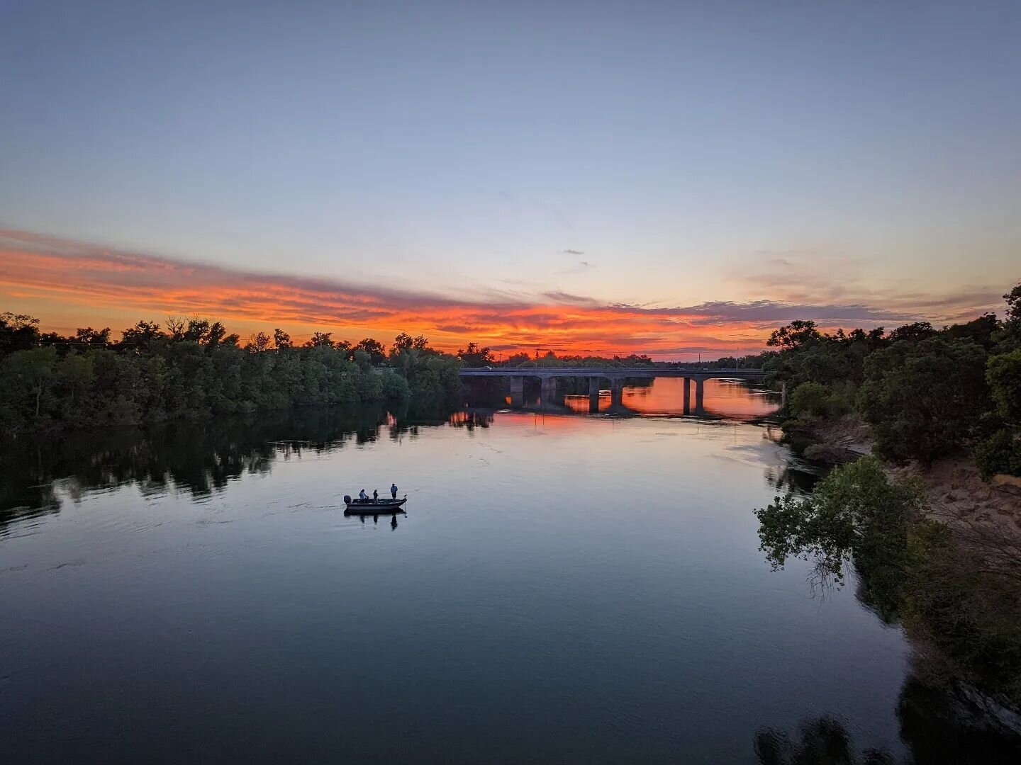 Sunset view off the American River Bike Trail from the Pipe Bridge. Looking west towards the 5 from the middle of the American River. 
.
Sacramento is the best! Ride your bike!  Call us if you need a buddy to help you explore! 
.
#visitsacramento #bi