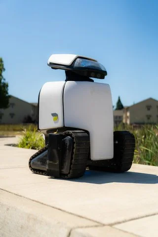 Dax ADA robot rolls down a sidewalk, collecting sidewalk accessibility measurements.