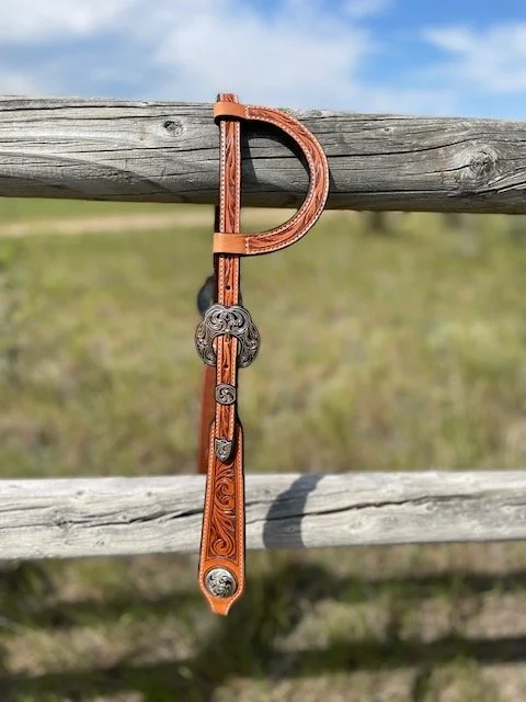 Floral tooled leather slide ear headstall with silver overlay buckles and conchos. Hand made, veteran owned, small business from the finest Hermann Oak Leather.  Fully lined and stitched. Made in Wyoming.