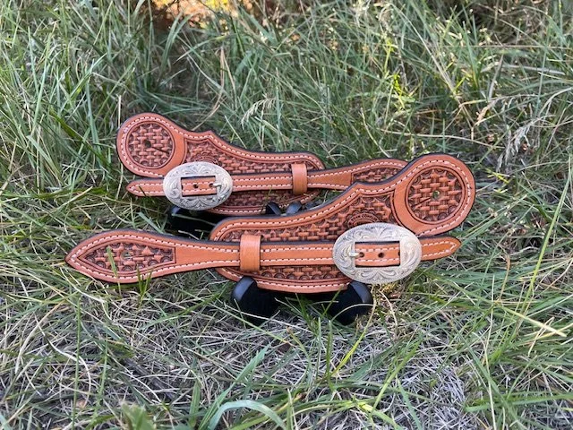 Basket weave slide thru spur straps. Hand made, veteran owned small business. Carved from the finest Hermann Oak Leather with silver overlay buckles. Made in Wyoming.