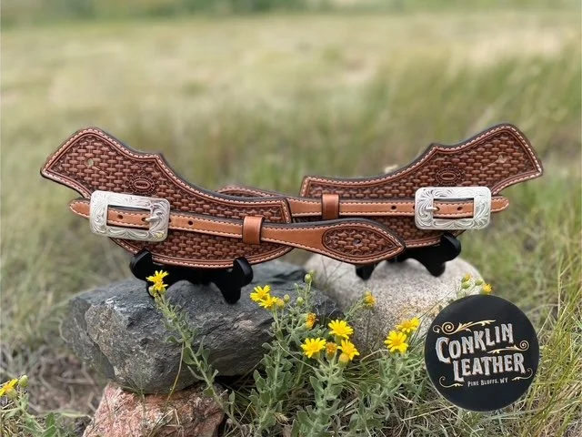 Basket weave slide thru spur straps. Handmade, veteran owned small business.  Carved from the finest Hermann Oak Leather with silver overlay buckles. Made in Wyoming.