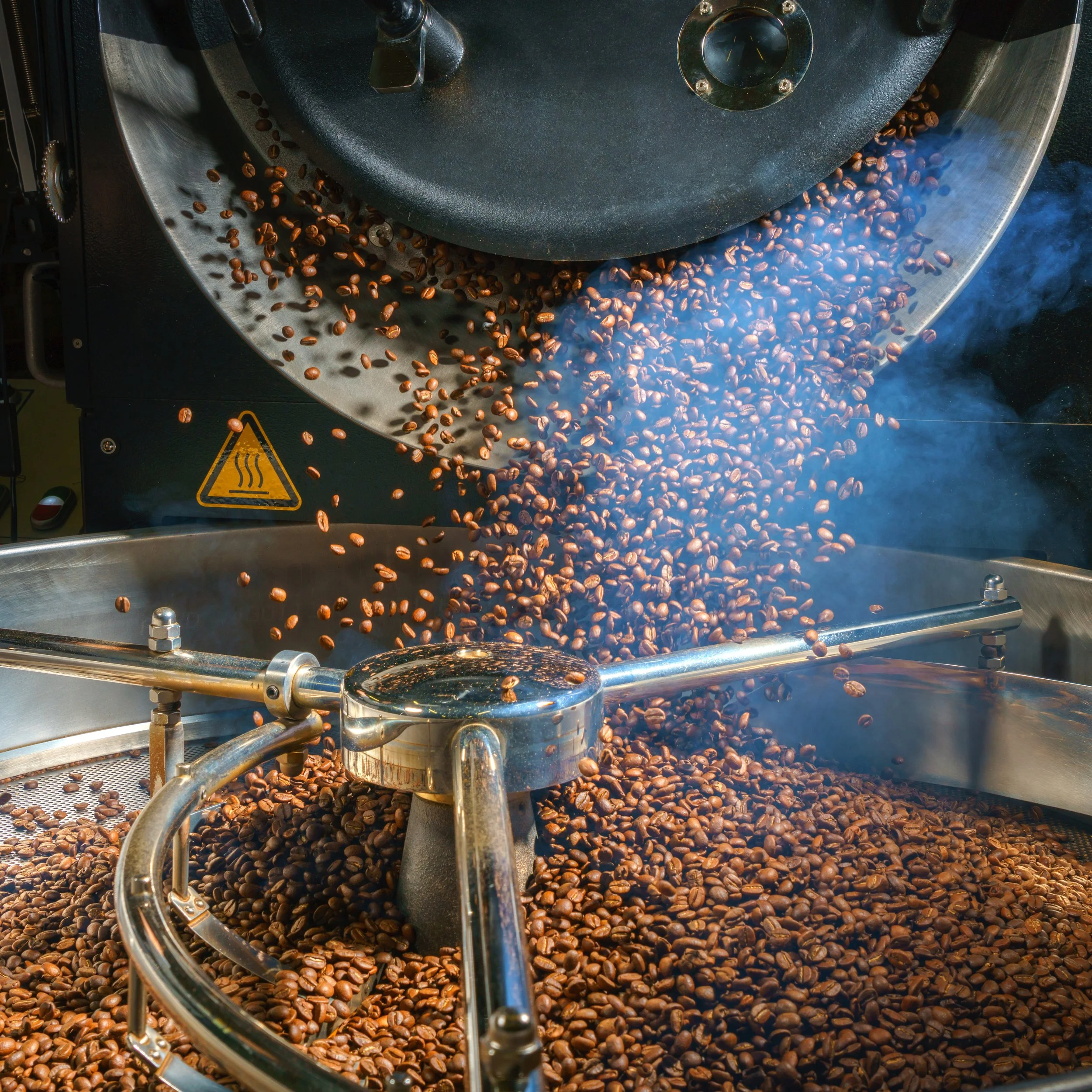 A Probat UG Series roaster discharges coffee into the cooling tray.