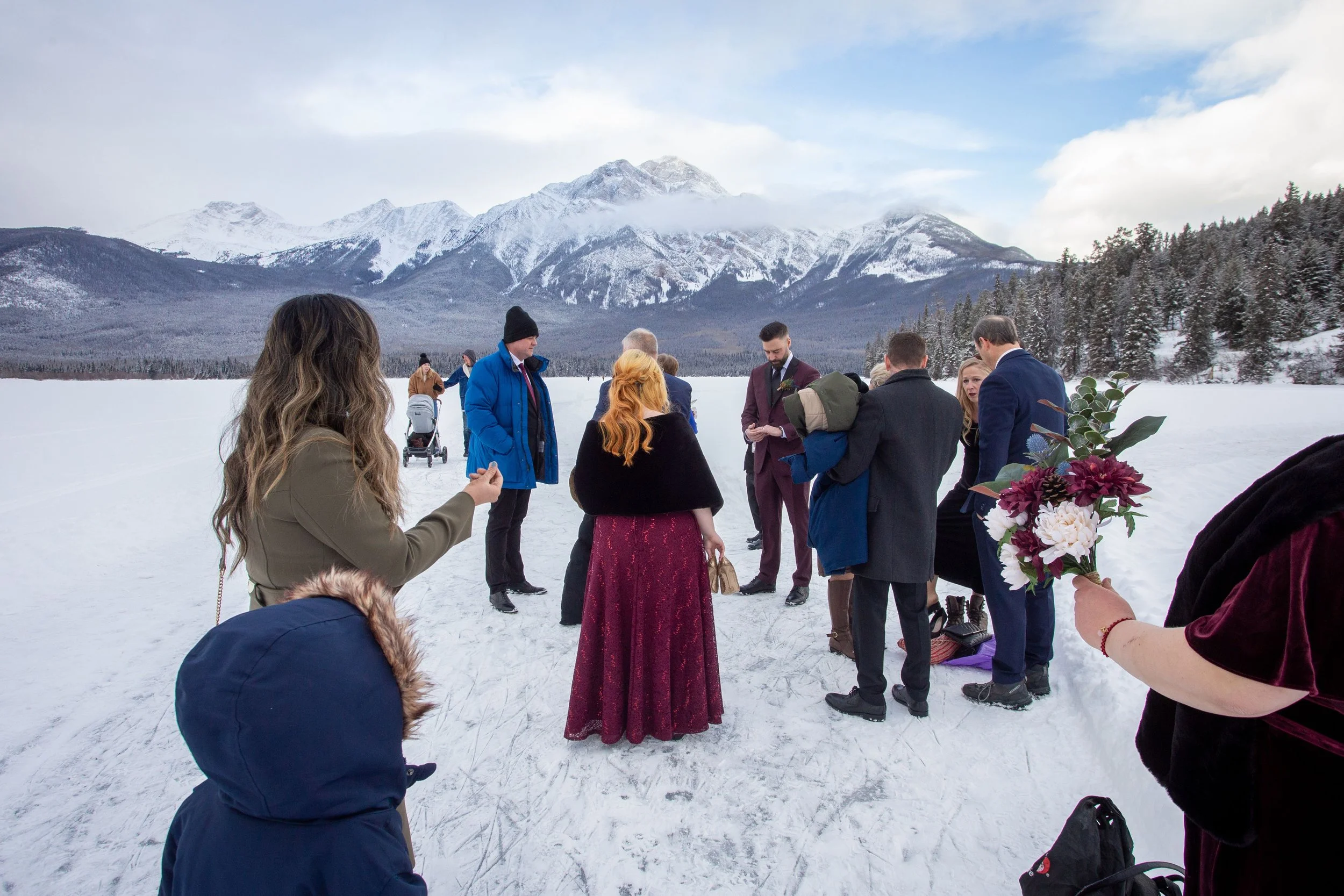 Behind the scenes of family portraits at a winter wedding in Jasper