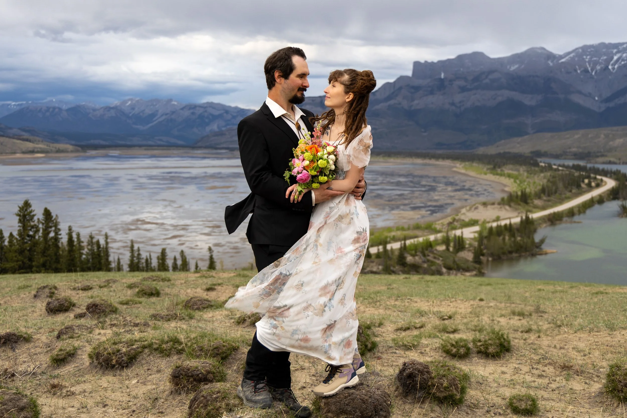 A Newlywed couple embraces for a photo in Jasper