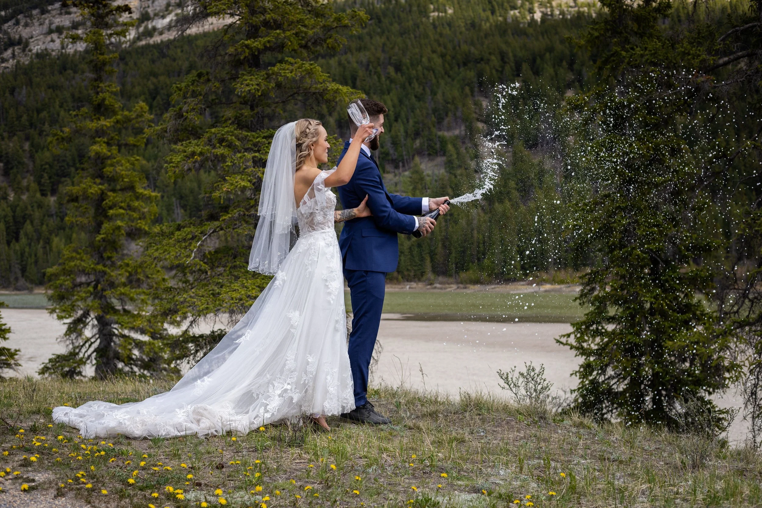 A Bride and Groom celebrate their wedding day with a champagne pop!