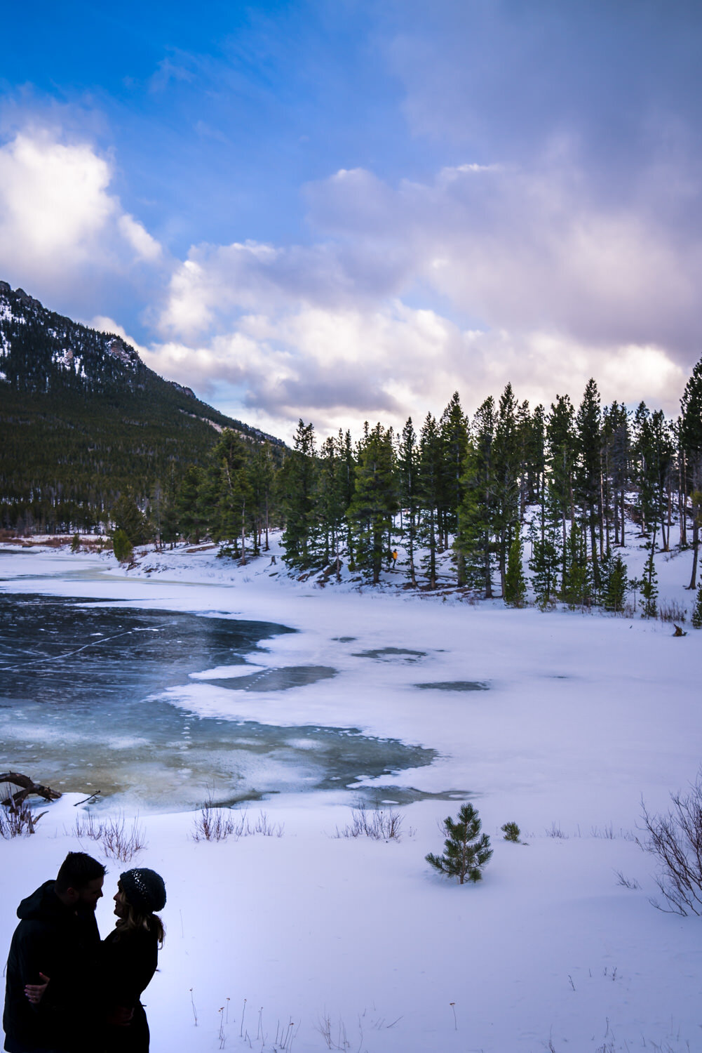  Snowy Estes Park Colorado engagement photos taken at Lily Lake in Rocky Mountain National. Photographed by JMGant Photography. 