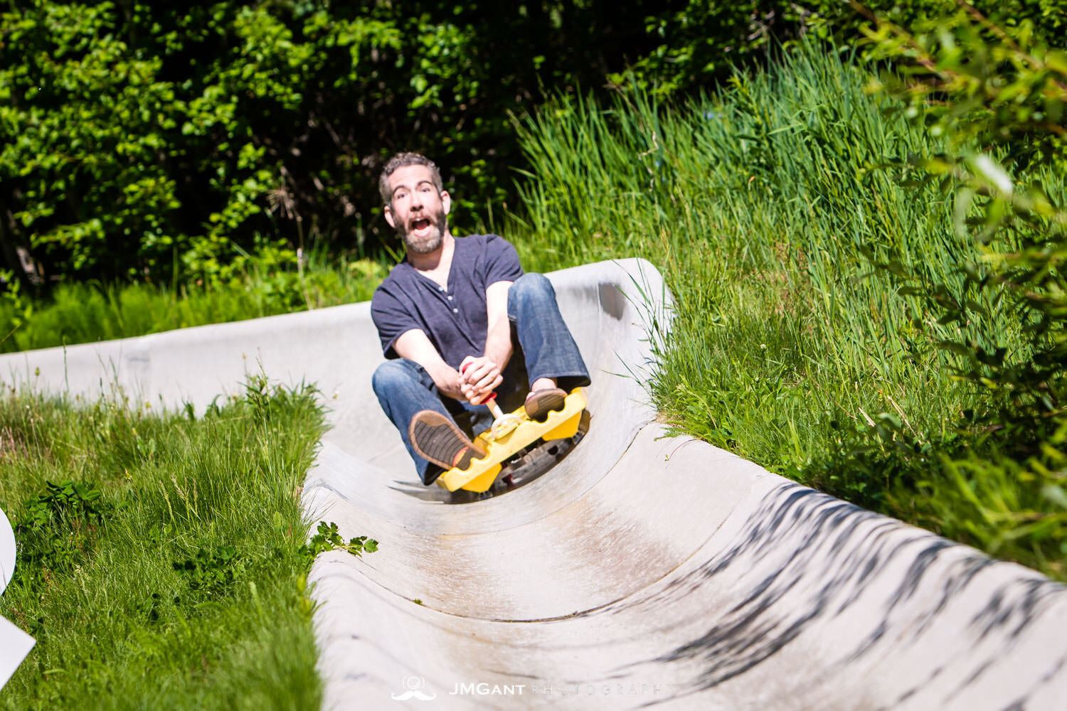  Bride and groom ride the Alpine Slide down at Winter Park, mountain wedding. 