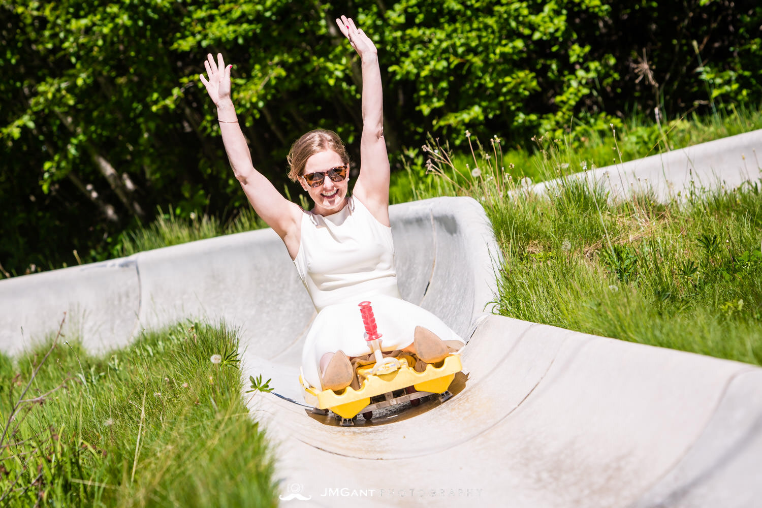  Bride and groom ride the Alpine Slide down at Winter Park, mountain wedding. 