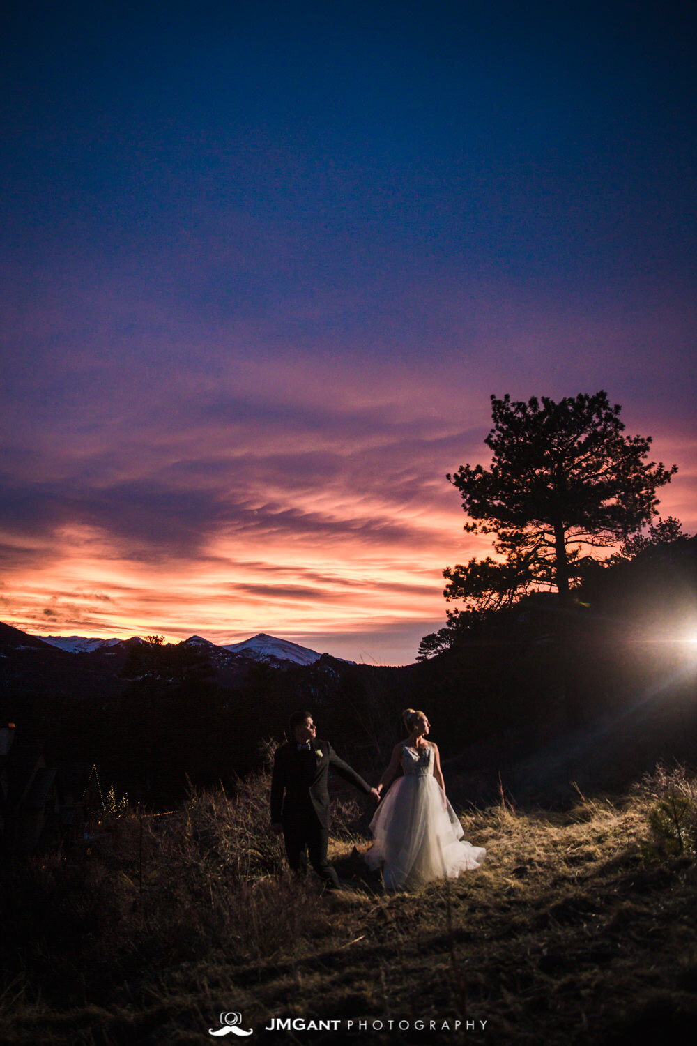  Colorful rocky mountian wedding sunset at the Della Terra Mountain Chateau in Estes Park Colorado. Photographed by Jared M. Gant of JMGant Photography. 