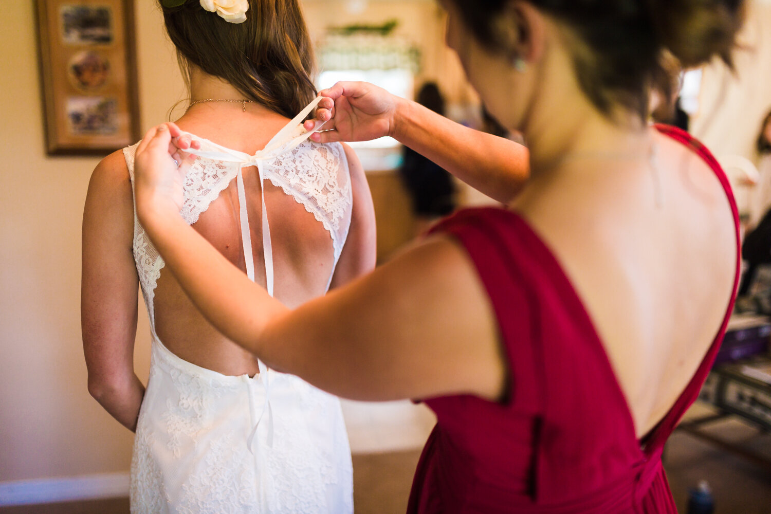  Bride getting in dress by JMGant Photography. 