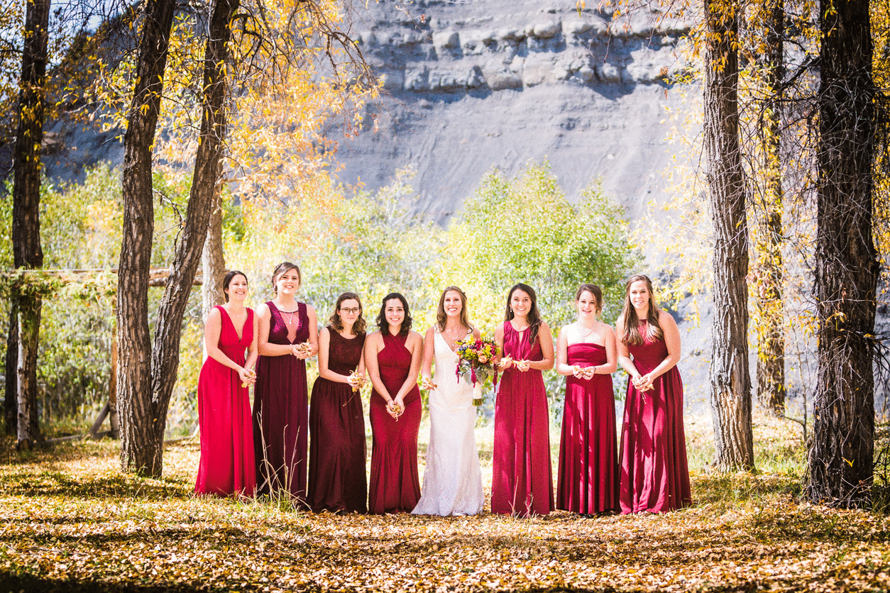  Bridesmaids throwing leafes by JMGant Photography. 