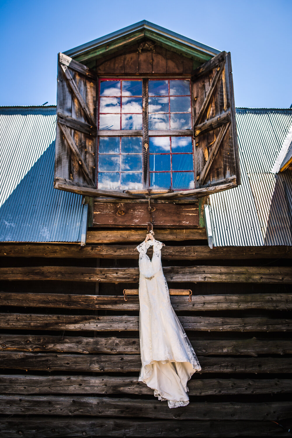  Wedding dress hanging at The Barn at Evergreen Memorial. Photographed by JMGant Photography 